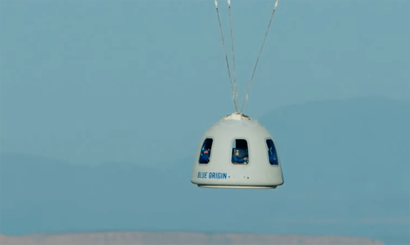 The New Shepard crew capsule descends under three drogue parachutes during its Dec. 11, 2021, test flight.
