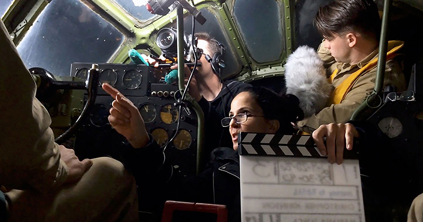 Mariana Tosca instructs cast member inside a B-29