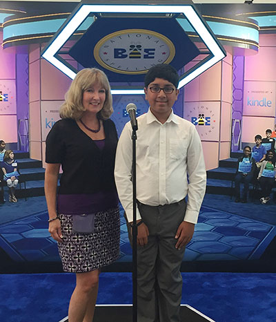 Mensan Deb Gribben joins her student Tejas Muthusamy in 2016, his third year as a National Spelling Bee finalist. Muthusamy will compete at the Bee again at the end of May, in his final year of eligibility.