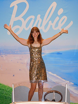 Image of Katherine Kerestman standing in front of Barbie text