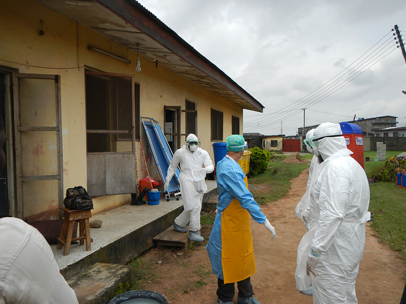 World Health Organization workers gear up to go into an old Ebola isolation ward in Lagos, Nigeria.