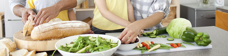 Family preparing healthy foods in the kitchen