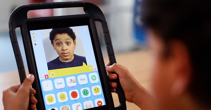 A person holding a tablet that displays a child making an excited facial expression