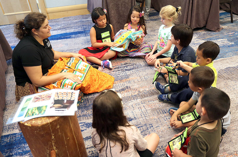 A group of children listen to a Spark presentation