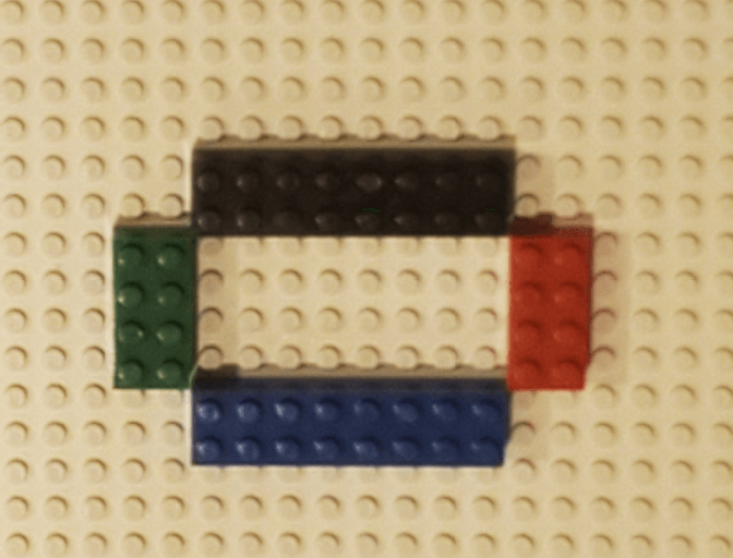 Several Legos arranged to constrain a marble