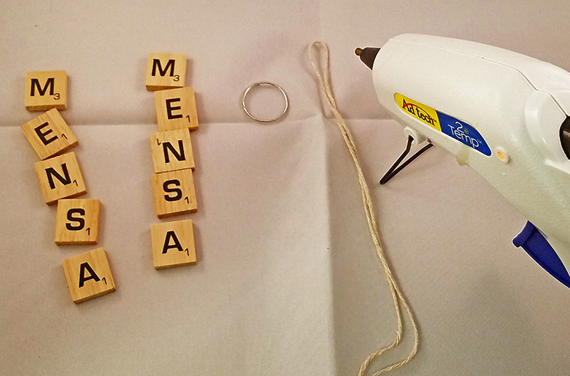 Parts for the Scrabble keyring laid out on particle board